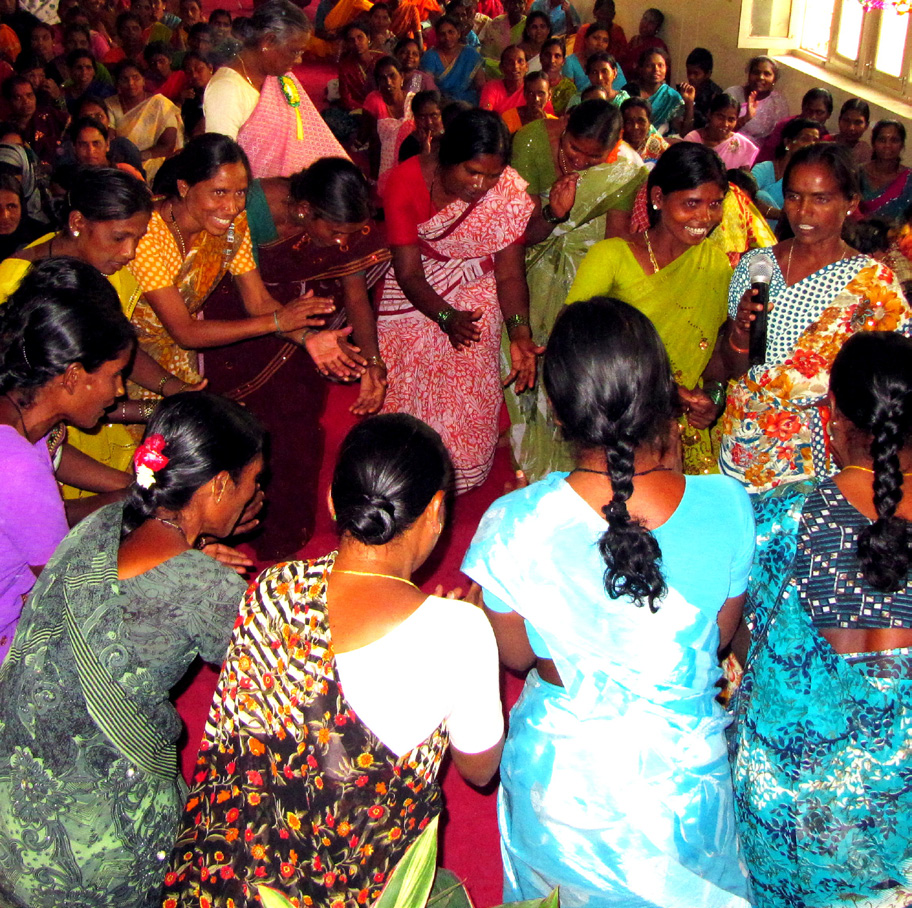Women participants of the Family Development Program in Hyderabad, Andra Pradesh celebrate their strengths and success through song and dance at an Annual Family Gathering.