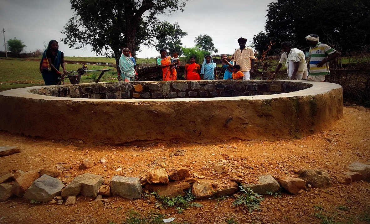 A wall was constructed around the well with stone, cement and sand and hard soil was added around it to stop the rain water from entering inside.